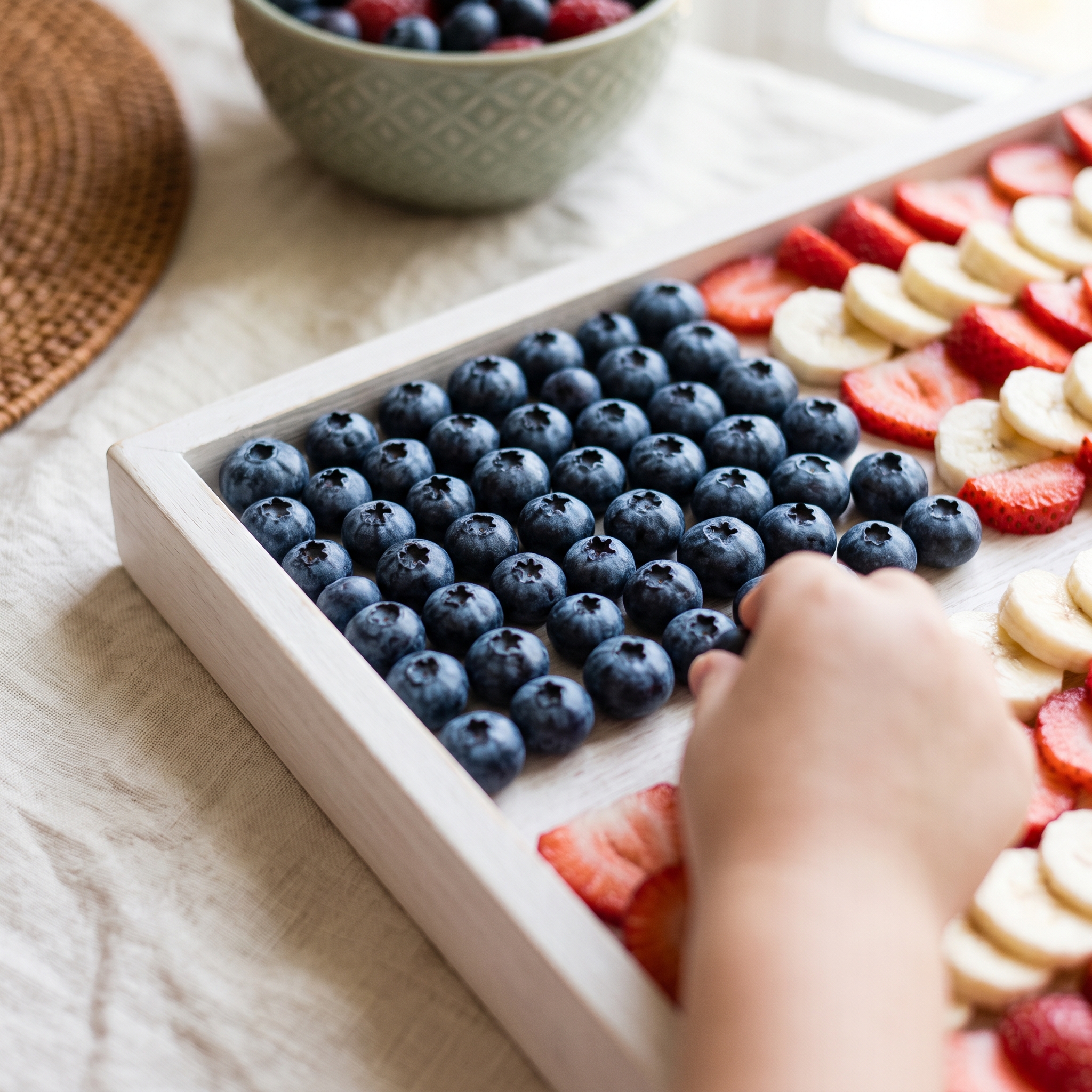 Close-up of tightly arranged blueberries filling the star field corner of an American flag fruit tray