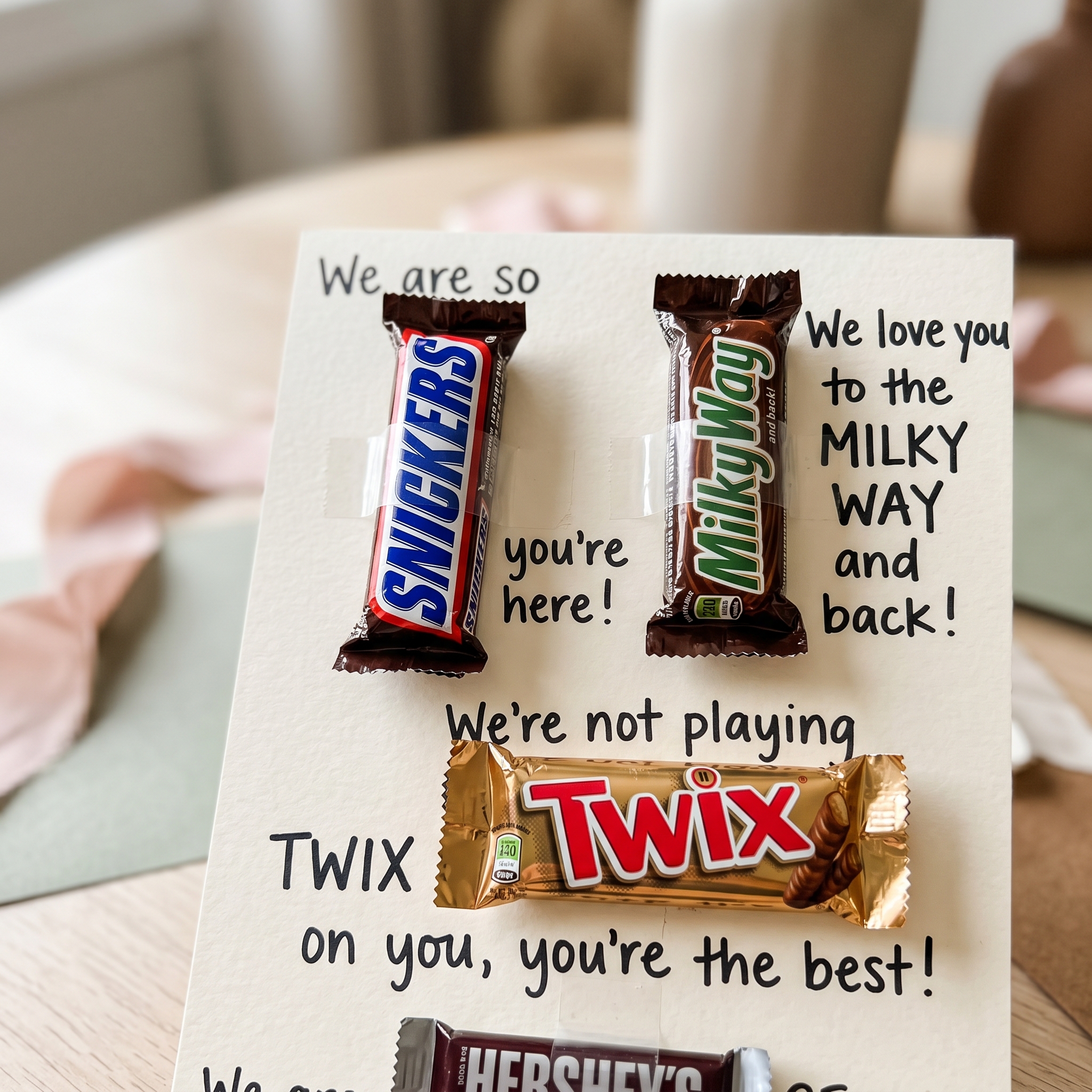 Close-up detail of candy gram birthday card showing Snickers and Milky Way bars taped into handwritten birthday message